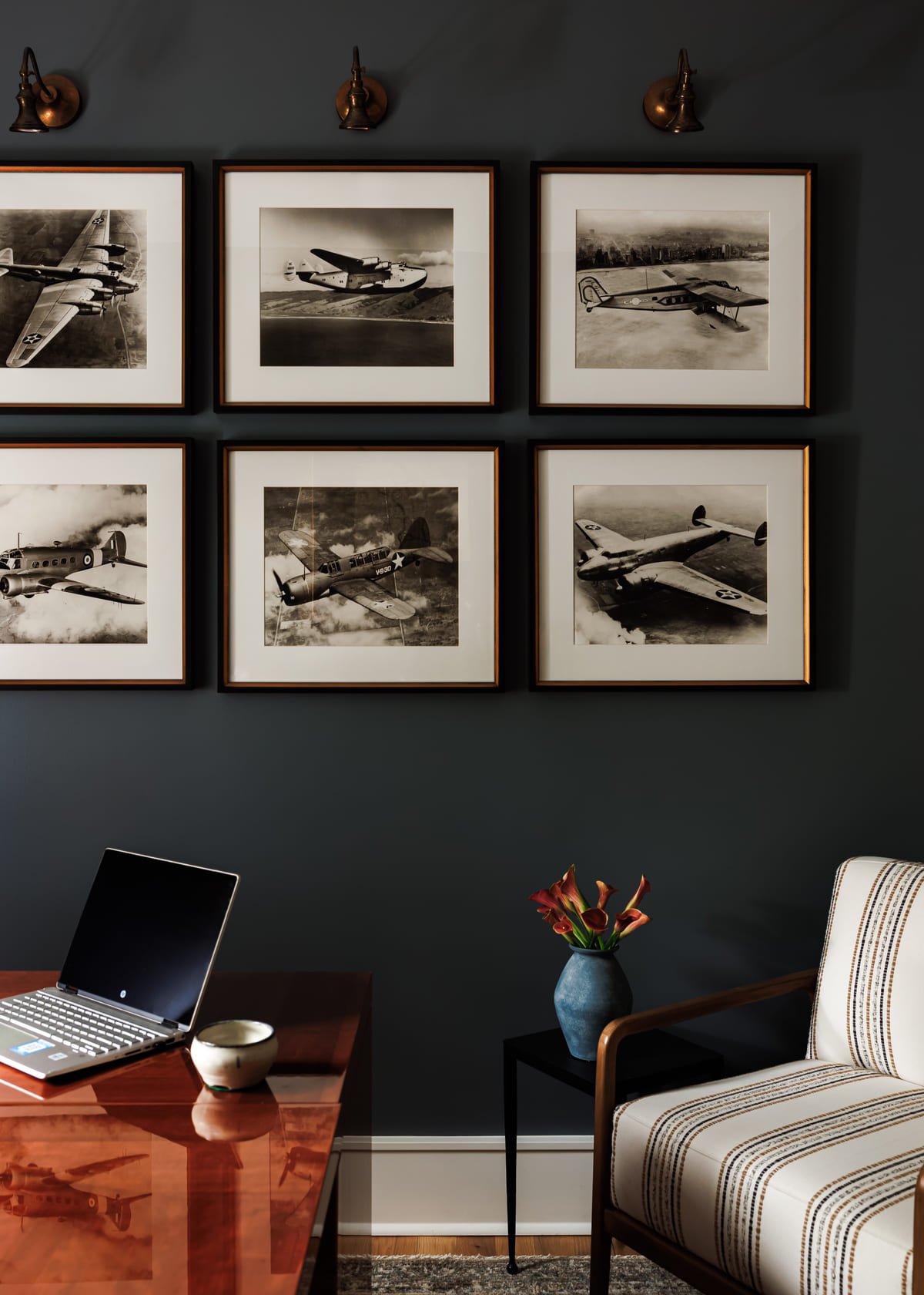 Charcoal office wall hung with black and white photography