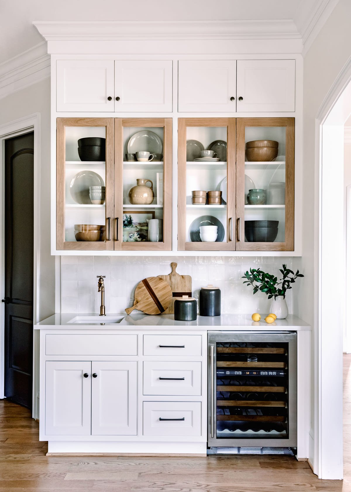 Home bar with glass fronted cabinets, open shelving, and a wine fridge