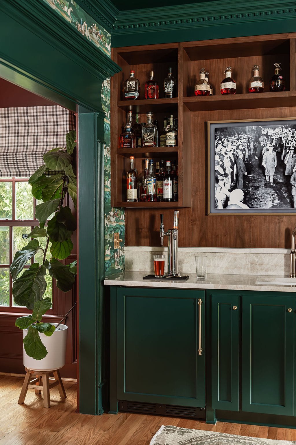 Bar cabinetry with a brass rail, open shelving, and bottle display