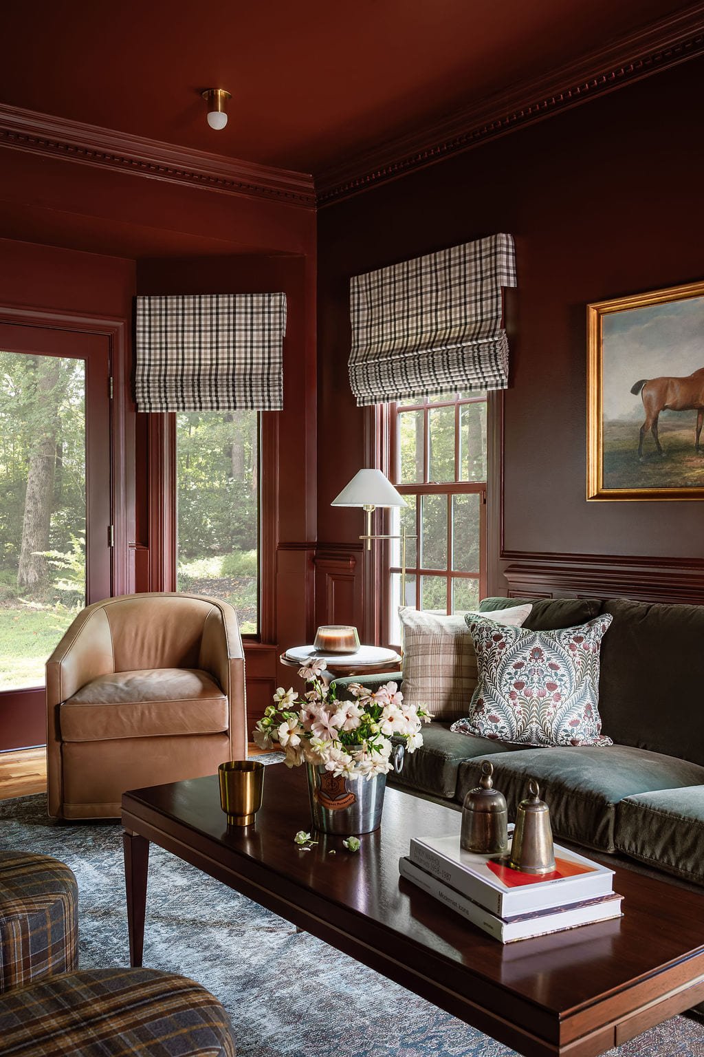 Lounge with leather club chairs, antique art, and layered lamplight