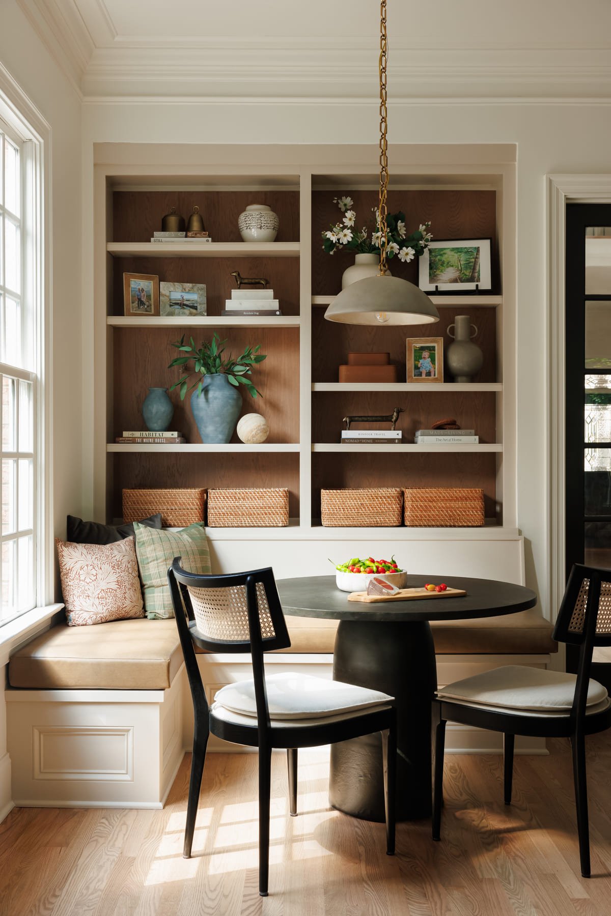 Breakfast banquette beneath open shelving in a new construction kitchen