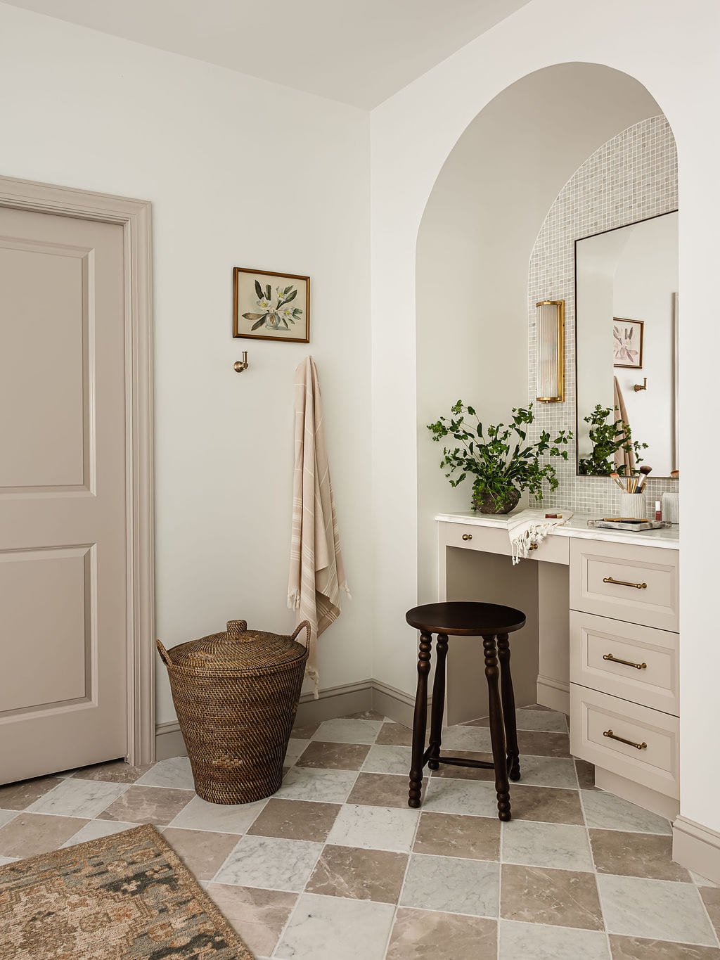 Hallway leading to an arched vanity alcove with a woven basket and stool