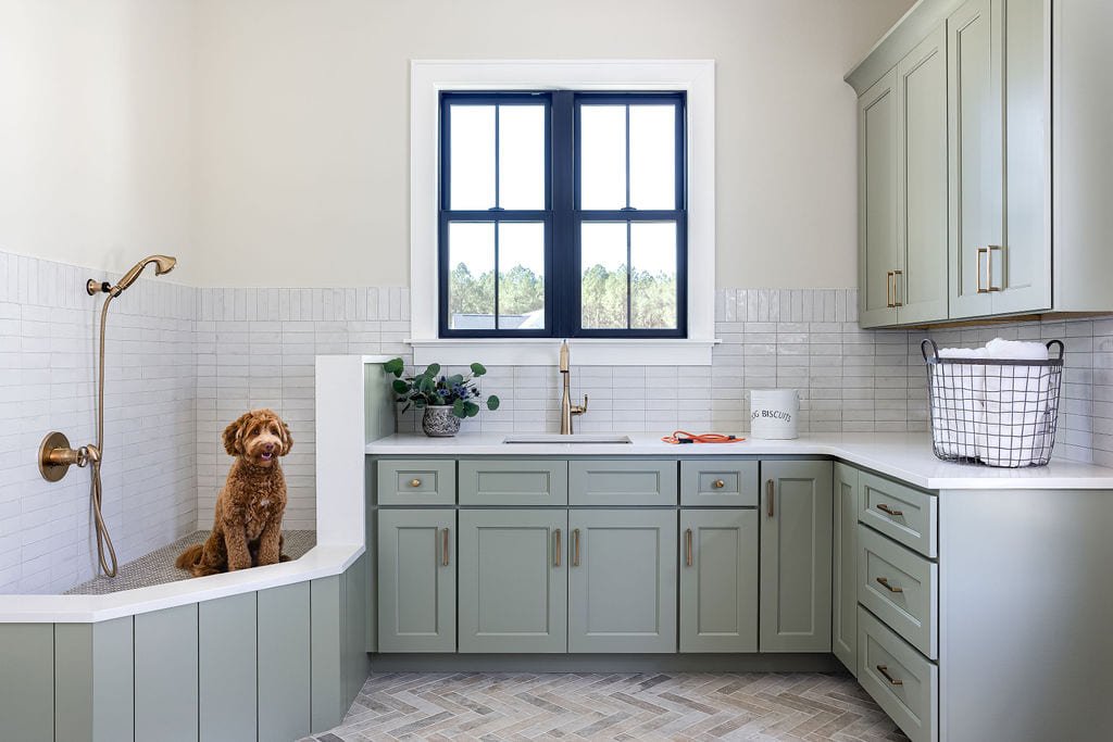 Laundry room with sage cabinetry and a tiled dog shower