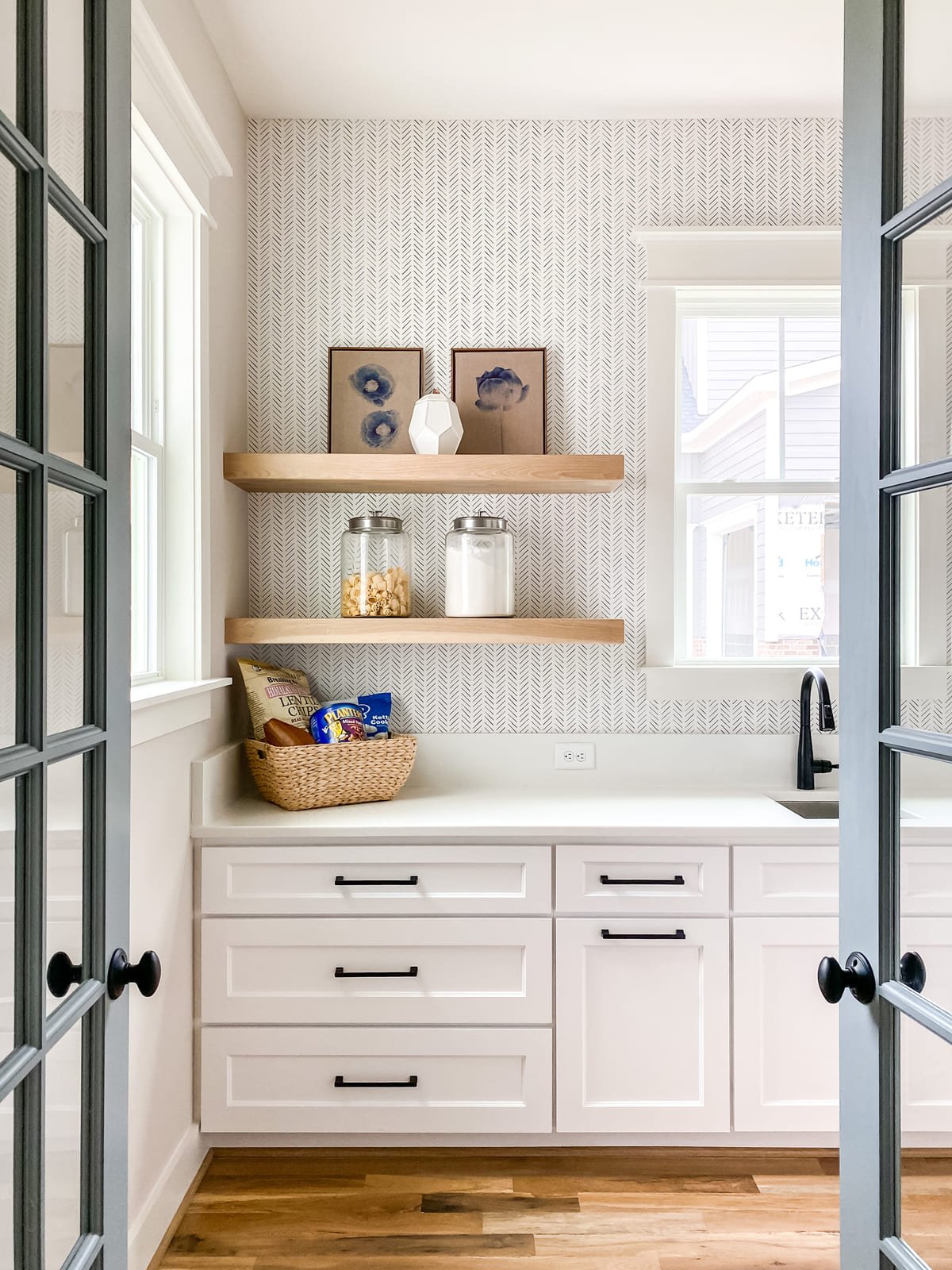 Kitchen with white cabinetry, open shelving, and glazed tile